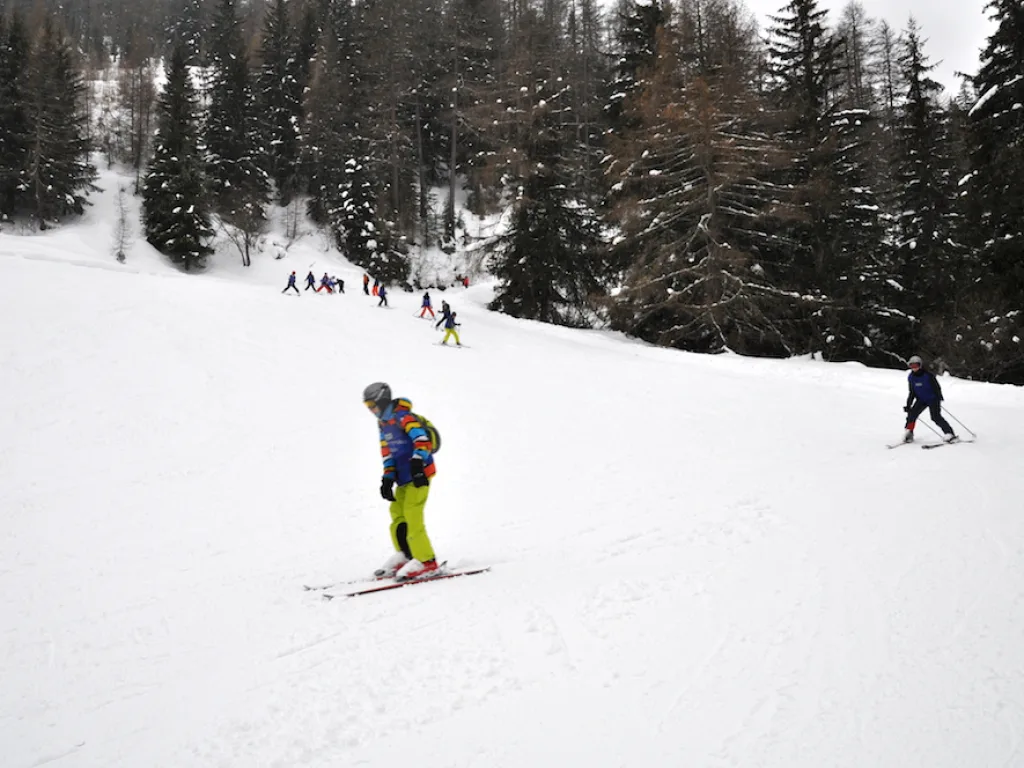 Skifahrerin fährt allein den Hang hinunter.